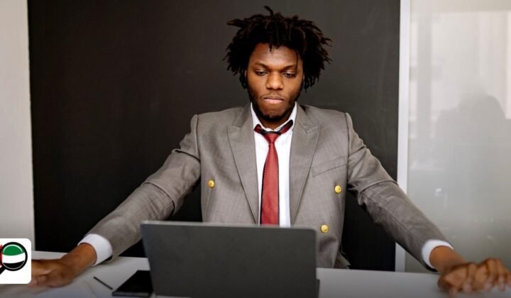 Economic Substance Regulations UAE Free Zones Reporting: A Complete Guide - businessman in a suit using a laptop at a white