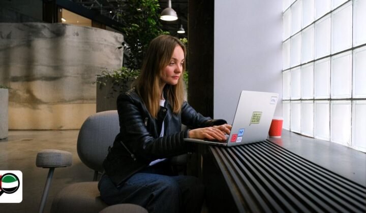 Step-by-Step Guide to Add Activity to Dubai Free Zone Licence - young woman working on a laptop in a stylish modern office