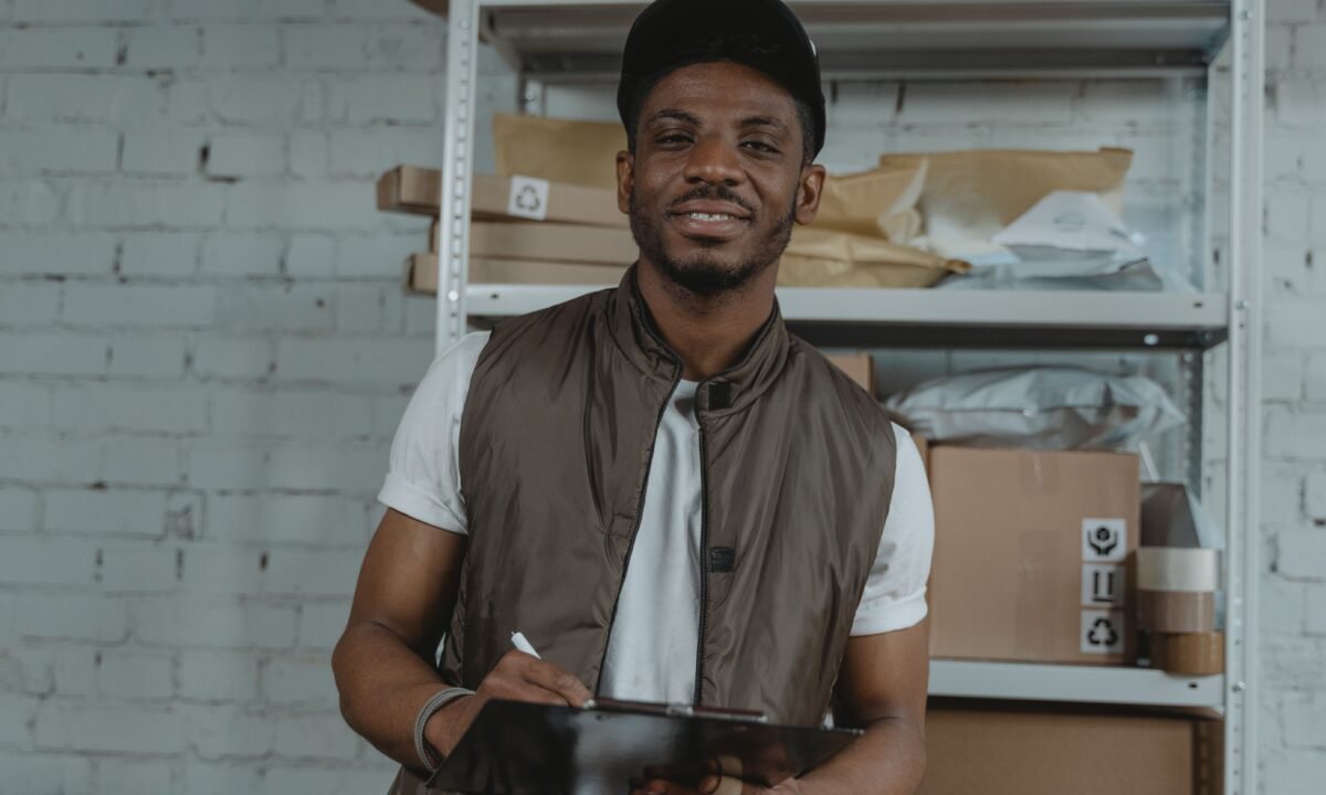 Warehouse employee with clipboard for UAE free zone logistics and freight forwarding
