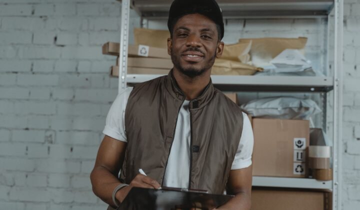 Warehouse employee with clipboard for UAE free zone logistics and freight forwarding