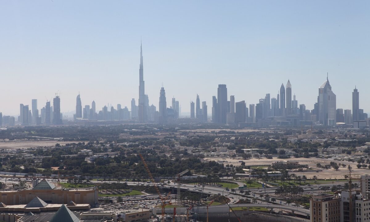 Dubai skyline and Downtown business district, the mainland jurisdiction UAE free zone companies convert into