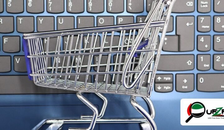 UAE free zone e-commerce business setup 2026 — miniature shopping cart on laptop keyboard