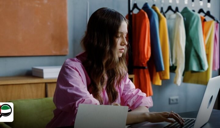Dubai World Trade Centre E-commerce License Cost 2026 - professional woman working at desk with laptop in fashion studio