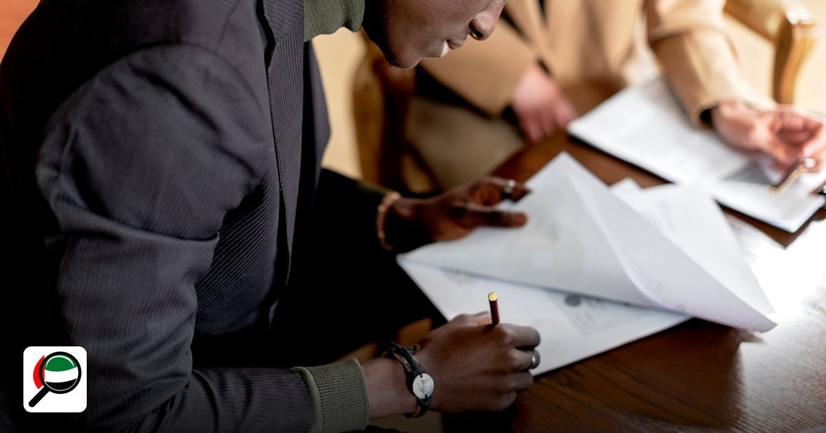 Free Zone Business Events Calendar 2024‑2025 - african man focused on signing important business documents at a desk