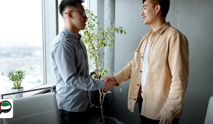 Gold & Diamond Park Cost for Indian & Pakistani Entrepreneurs - two businessmen shaking hands in a modern office setting