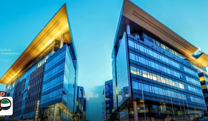Gold & Diamond Park vs DMCC: Which is Cheaper in 2026? - futuristic glass office buildings at sunset in an urban area