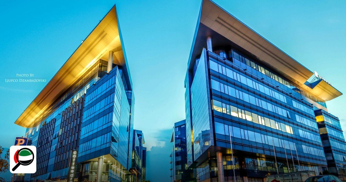 Gold & Diamond Park vs DMCC: Which is Cheaper in 2026? - futuristic glass office buildings at sunset in an urban area