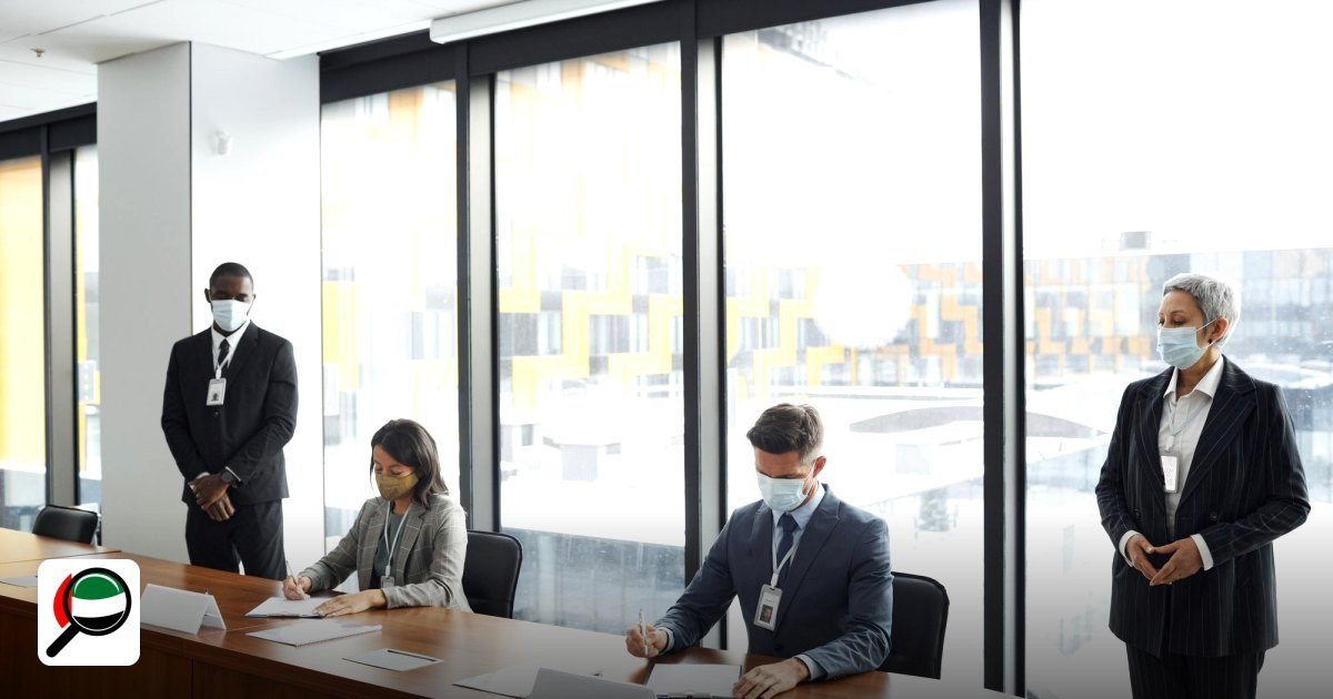 How to Set Up a Company in a UAE Free Zone: Step by Step - colleagues in a meeting room wearing masks, signing documents