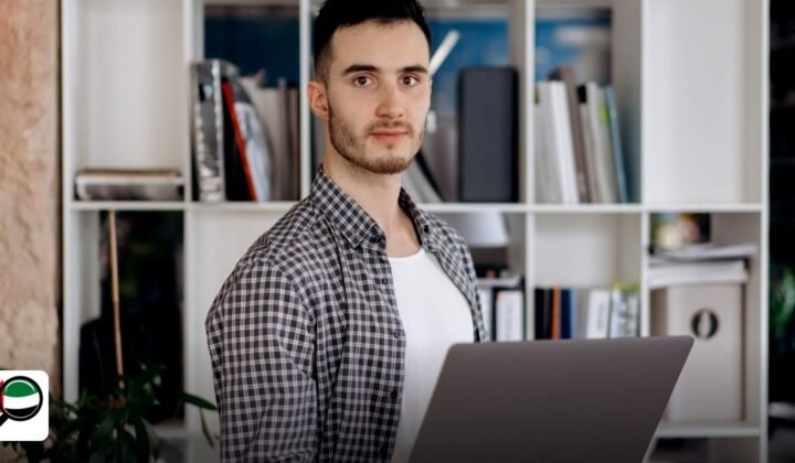 Step‑by‑step guide to setting up a free zone company in the UAE for e‑commerce businesses - man holding laptop in modern